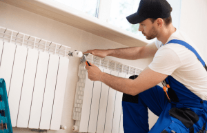 A technician fixing a broken radiator