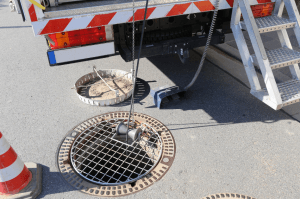 Plumber inspecting sewer using a camera