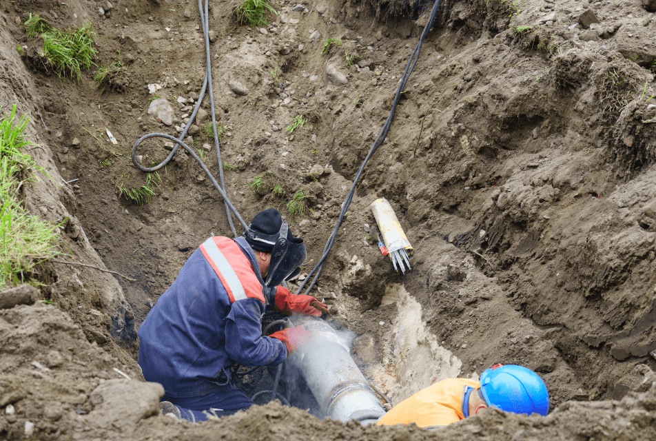 worker fixing a broken water main