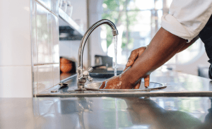 Washing hands in commercial kitchen faucet