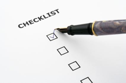 marking off a checklist with a pen